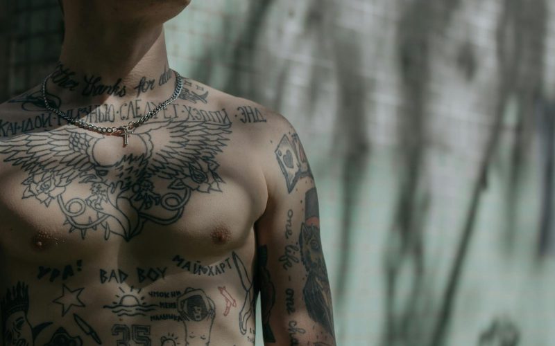 Close-up Shot of a Man's Chest with Tattoo