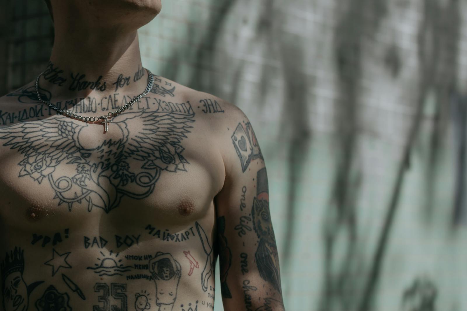 Close-up Shot of a Man's Chest with Tattoo